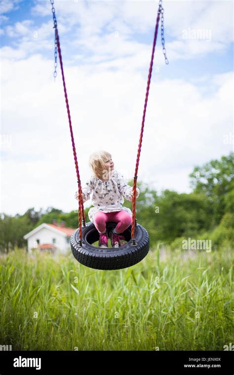 Girl On Tire Swing Stock Photo Alamy