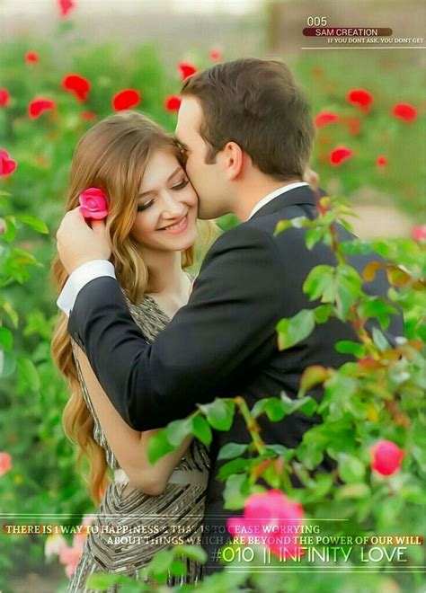 A Man And Woman Kissing In Front Of Red Flowers With The Caption Love Is In The Air
