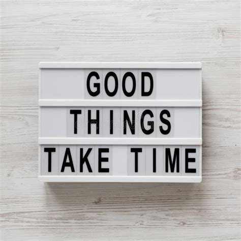 `good Things Take Time` Words On A Lightbox On A White Wooden