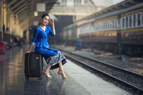 Passenger Traveler Woman In Train Station Waiting By Sasin Tipchai On