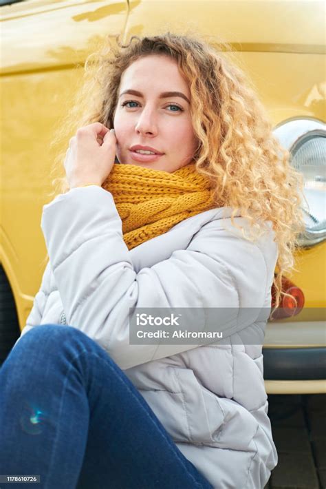 Portrait Of Young Attractive Redhead Curly Girl Siting Front Of Yellow