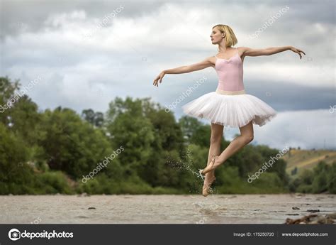Ballerina Jumping Above River — Stock Photo © Bezikus 175250720