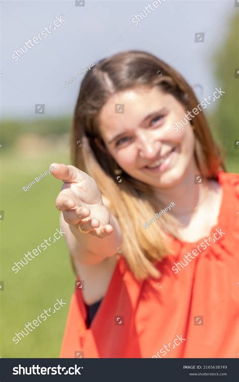 Portrait Happy Young Woman Reaching Out Stock Photo 2165638749
