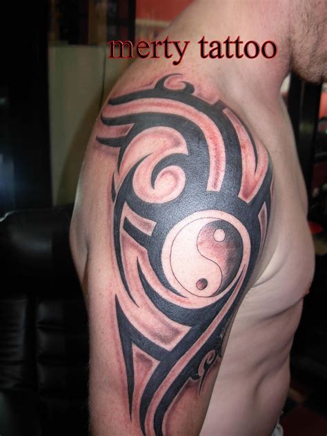 Tribal and logo tattoo | merty tattoo
