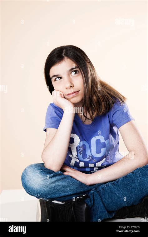 Girl Sitting And Thinking With Her Legs Crossed Stock Photo Alamy