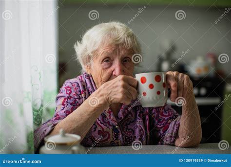 Portrait Of An Elderly Woman Sitting At The Table Stock Image Image