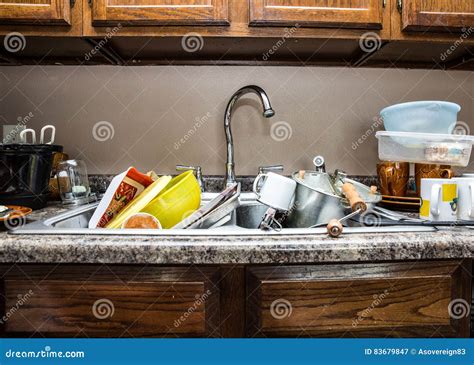 Messy Kitchen Counter With Pile Of Dirty Dishes In Sink Compulsive