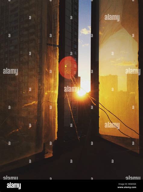 Building Seen Through Glass Window During Sunset Stock Photo Alamy