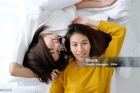 Lgbt Young Cute Asia Lesbians Lying And Smiling On White Bed Together In The Morning Couple