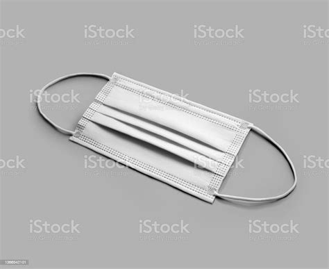 Mockup Of A Clean Folded White Surgical Mask With Ear Loops Isolated On