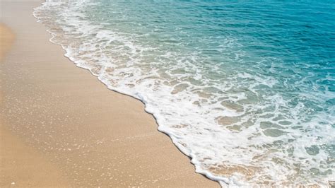 Wave Of Blue Ocean On Sandy Beach Background Premium Photo