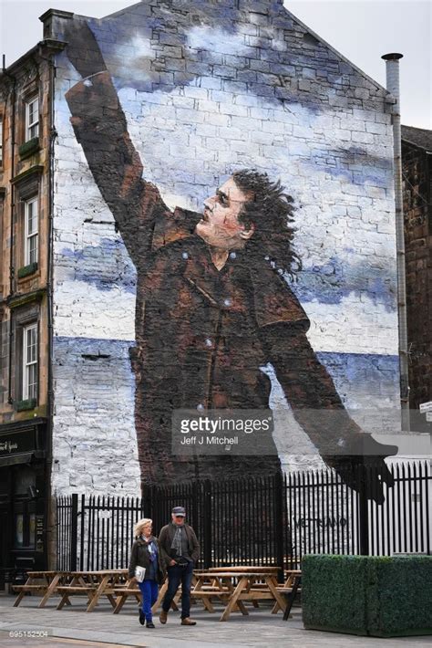 A Mural Of Comedian Billy Connolly Displayed On A Gable Wall In The