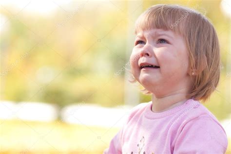 Beautiful Little Girl Crying On The Autumn Forest Stock Photo By