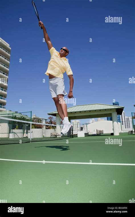 African Tennis Player Jumping With Racket Stock Photo Alamy