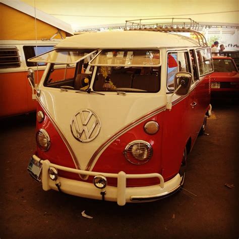 A Red And White Vw Bus Parked In A Garage