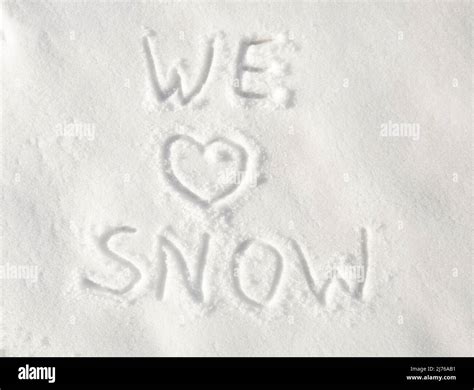 Text We Love Snow Written In Snow With A Heart For Love Stock Photo