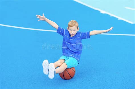 Adorable Child Playing The Basketball In The Basket Field Stock Image