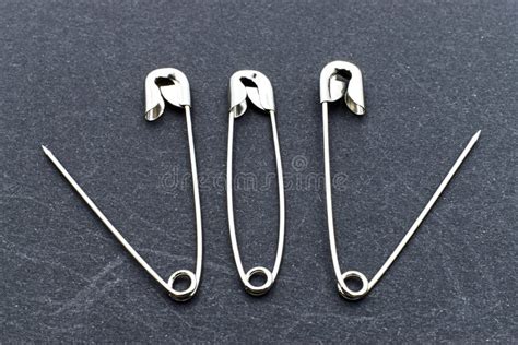 Safety Pin Open And Closed Isolated On Dark Background Stock Photo