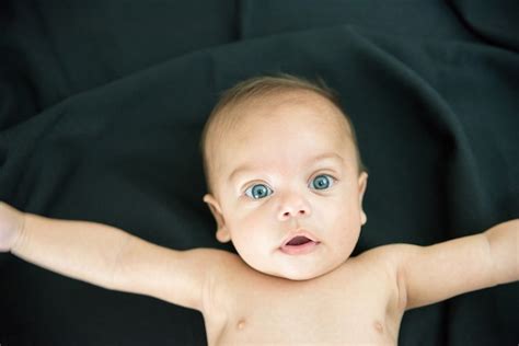 Premium Photo Blue Eyed Naked Baby Lying On Black Fabric