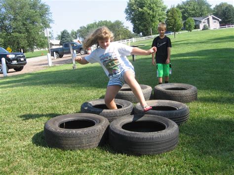 Tire Hopping at End of Summer Obstacle Course - Loup City Public Library