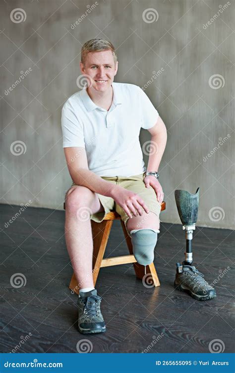 Leg Amputee Sitting On Stool With Prosthetic Leg To The Side Royalty