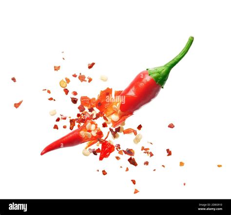Chili Flakes Bursting Out From Red Chili Pepper Over White Background