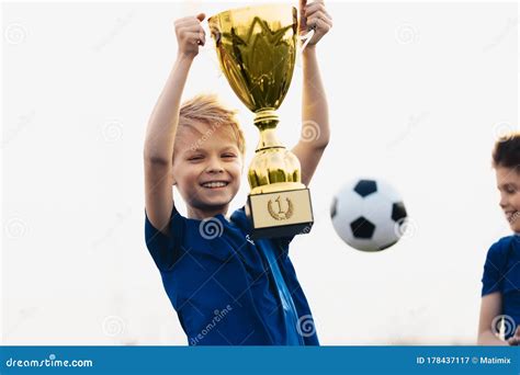 Happy Boy Rising Golden Trophy Child Winning Sports Competition Stock