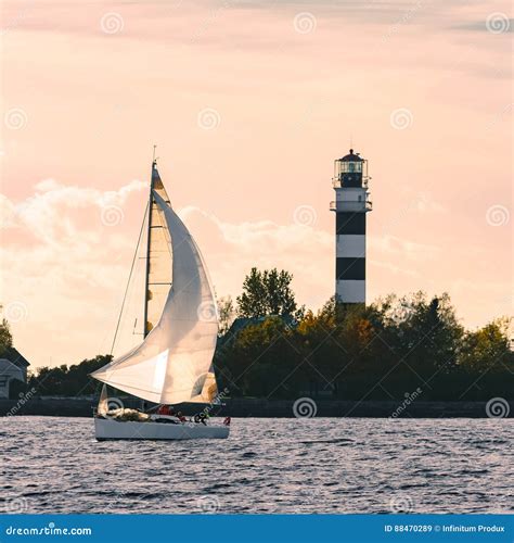 Sailboat Moving Past The Big Lighthouse Stock Image Image Of Sport