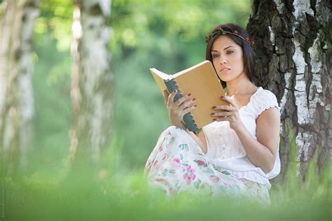 Young Woman Reading A Book In Nature By Mosuno Stocksy United