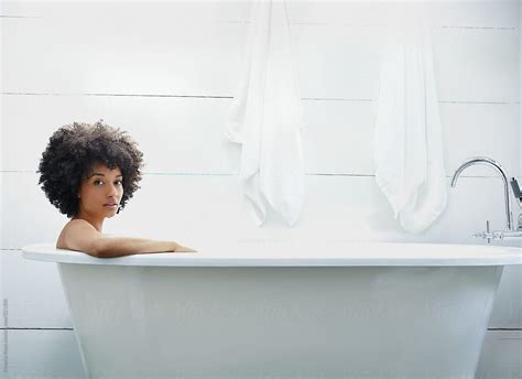 Portrait Of Woman Relaxing In Farmhouse Bathtub By Stocksy