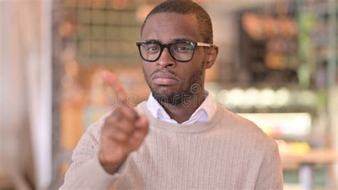 Portrait Of Serious African Man Saying No By Finger Sign Stock Image