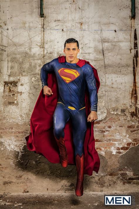 a man dressed as superman poses for a photo
