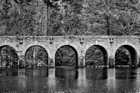 Old Stone Bridge Reflecting In A River In Winter Img8523 Black And