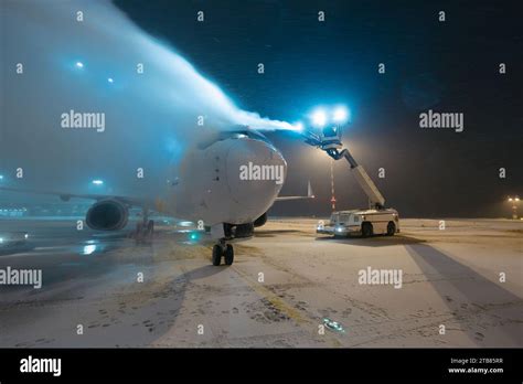 Deicing Of Airplane Before Flight Winter Frosty Night And Ground