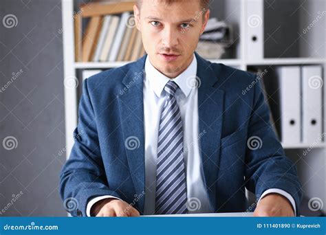 Serious Businessman In The Office Examines Stock Photo Image Of