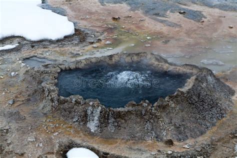 Bubbling Hot Geothermal Spring Surrounded With Snow In Yellowstone