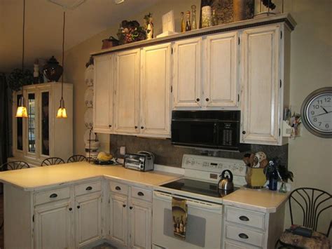Rub the sandpaper gently and lightly on the cabinets. distressed cabinets | Distressed kitchen cabinets ...