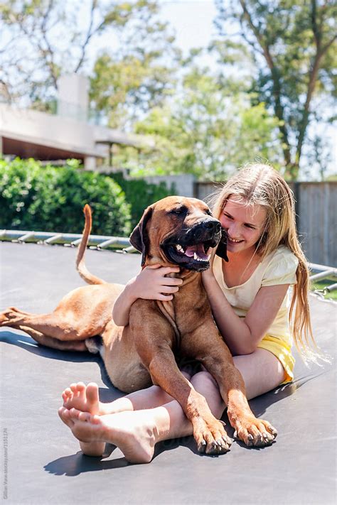 Tween Girl With Her Pet Dog Del Colaborador De Stocksy Gillian Vann