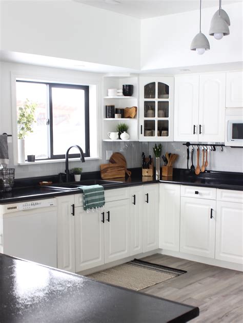 White kitchen cabinets are easily the most popular color choice, and there is or maybe the bold contemporary look of white cabinets on top, black cabinets on bottom, with personally, i love the sunny, fresh look of white kitchen cabinets and countertops complemented by yellow walls and. White Kitchen Cabinets with Black Countertops Are the Next ...