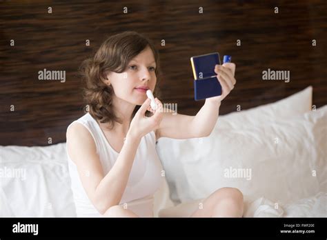 Woman Putting On Lipstick In Hi Res Stock Photography And Images Alamy