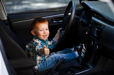 Premium Photo Cute Little Boy Driving Fathers Car