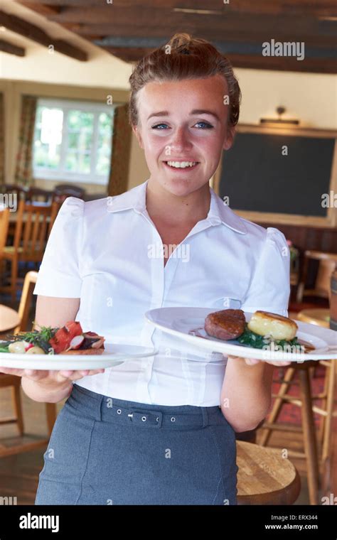 Portrait Of Waitress Serving Food In Restaurant Stock Photo Alamy