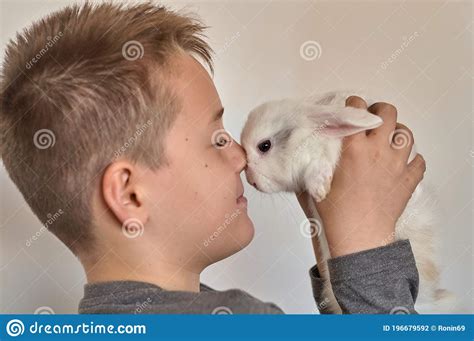 A Boy With A White Rabbit In His Hands Stock Photo Image Of Small