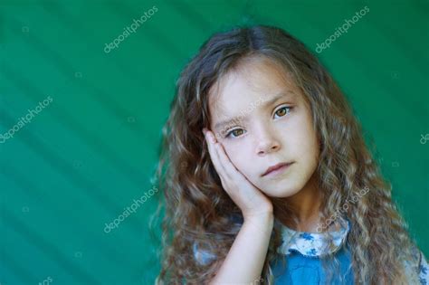 Beautiful Sad Little Girl With Curly Hair Close Up Stock Photo By