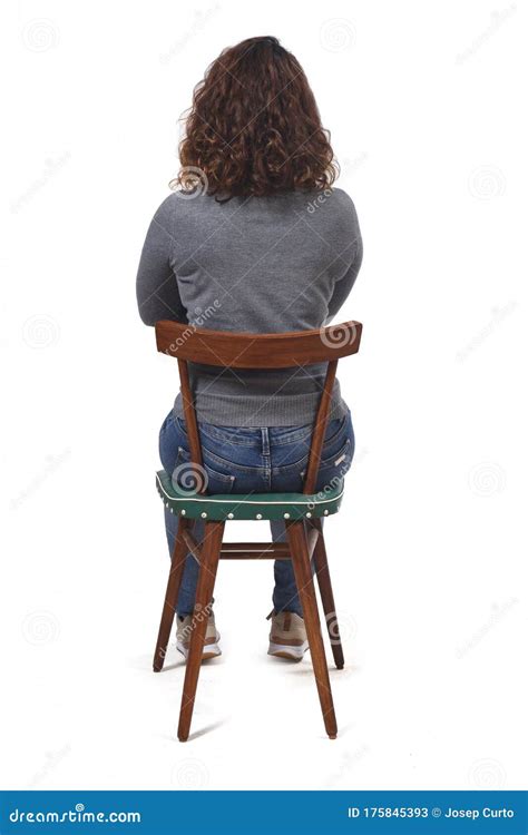 rear view of a woman sitting on chair on white background arms crossed stock image image of