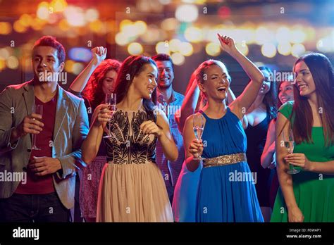 Happy Friends With Champagne Dancing At Nightclub Stock Photo Alamy