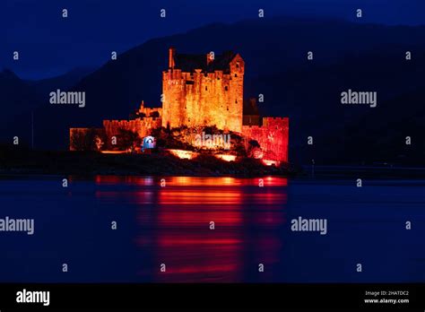 Eilean Donan Castle Bathed In Red Light For Poppy Day Stock Photo Alamy