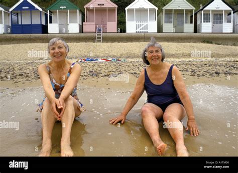 Southwoldsuffolk Uk 2 Elderly Women On Sitting On Beach In Swimming