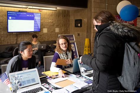 Nu votes volunteers speak to students at a voter registration booth. NUVotes | Northwestern's comprehensive 50-state voter-registration hub