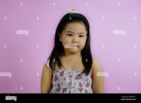 A Half Body Shot Of A Cute Young Chubby Asian Girl Looking Straight At The Camera Smiling
